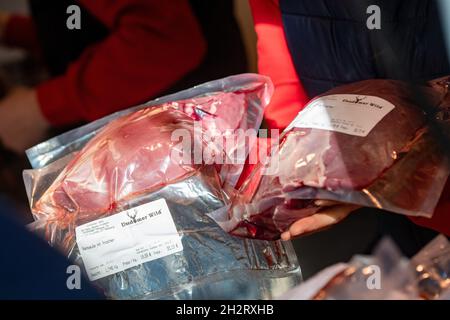 Neu Pudagla, Deutschland. Oktober 2021. Eine Verkäuferin der Firma Usedomer Wild verkauft auf dem Gelände des Forstamtes in Neu Pudagla in der Gemeinde Ückeritz ein Wildbein mit Knochen aus einem Verkaufswagen. Wildfleisch neigt dazu, eine Nische in der deutschen Ernährung zu besetzen. Doch die Händler in Mecklenburg-Vorpommern verzeichnen eine wachsende Nachfrage. Quelle: Stefan Sauer/dpa/Alamy Live News Stockfoto