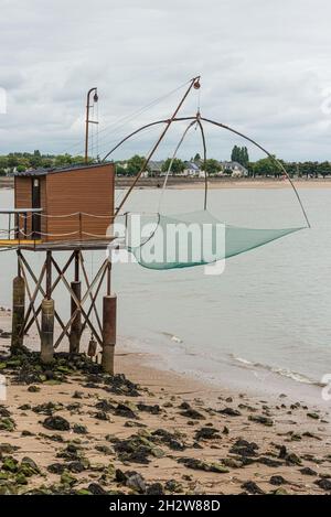 Fischerhütten und Netze entlang der Küste in St. Nazaire, Frankreich Stockfoto