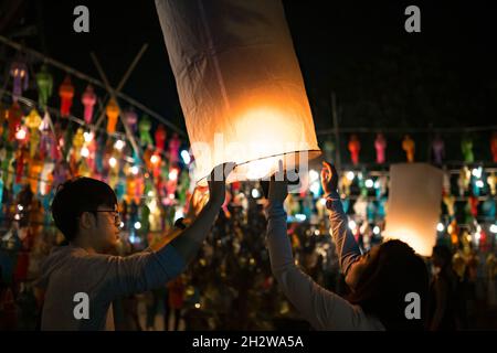 Chiang Mai, Thailand - 3. November 2017: Nicht identifizierte Menschen zünden die Laternen während des Loy Krathong Festivals an. Stockfoto