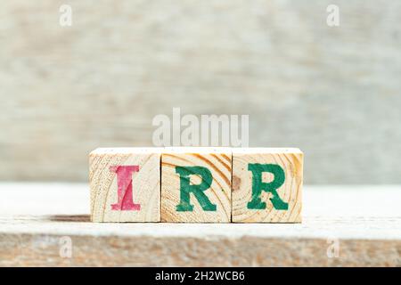 Alphabet letter block in word IRR (Abbreviation of internal rate of return) on wood background Stockfoto