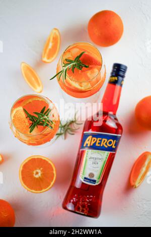 Italienische Tinktur Aperol für die Herstellung von Cocktail Aperol Spitz. Rot-orange Wein in einer Flasche. Alkoholisches Getränk. Aperitif mit Orangen und Kräutern. Essen Stillleben auf weiß. Ukraine, Kiew - 26. August 2021 Stockfoto