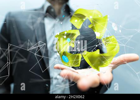 Die Hand eines Mannes mit illustriertem volumetrischen grünen Recycling-Schild Stockfoto