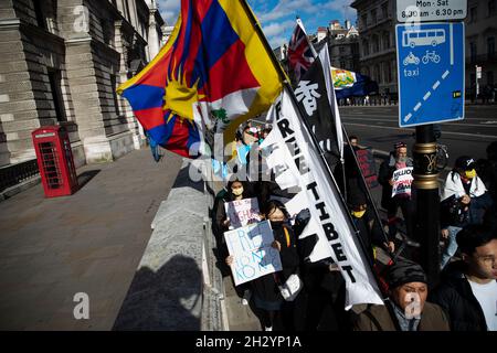 London, Großbritannien. Okt. 2021. Die Demonstranten halten während der Demonstration Fahnen und Plakate, auf denen ihre Meinung zum Ausdruck kommt.Eine Kundgebung, die von sechs verschiedenen Menschenrechtsgruppen aus Uiguren, Tibet und Hongkong organisiert wurde und zu „Sagen Sie Nein zu den Olympischen Winterspielen in Peking, sagen Sie Nein zum Völkermord“ aufrief, die mit drei Kernaufgaben verbunden war: „Protest gegen die Olympischen Winterspiele 2022 in Peking“, „Unterstützung der Uiguren, Tibeter und der Menschen in Hongkong“ und „eine Fackelstaffel zur Interpretation des olympischen Geistes“. Kredit: SOPA Images Limited/Alamy Live Nachrichten Stockfoto