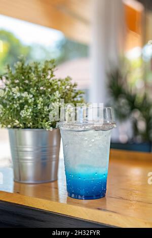 Eistee in Plastikbecher auf den Tisch gestellt Stockfoto