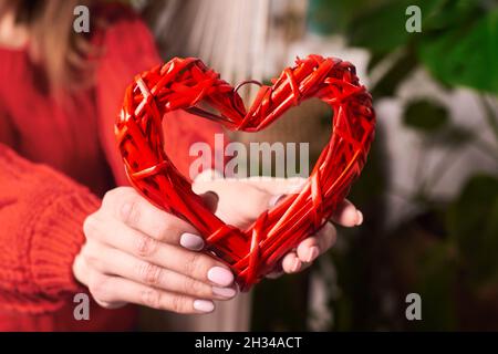 Frau hält rotes Herz in ihren Händen. Valentinstag-Konzept. Stockfoto