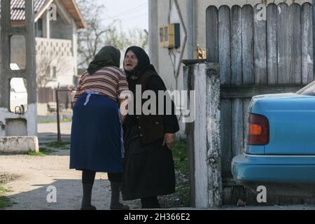 Varasti, Rumänien, 5. April 2009: Zwei alte Frauen sind auf einer Straße im Varasti Dorf, Rumänien im Chat. Stockfoto