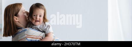 Frau mit Kleinkind Tochter mit Down-Syndrom zu Hause, Banner Stockfoto