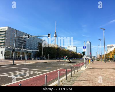 BERLIN, DEUTSCHLAND - 24. OKTOBER 2021: Karl-Marx-Allee an einem Sonntag ohne Verkehr. Alexanderplatz mit dem berühmten Fernsehturm im Hintergrund o Stockfoto