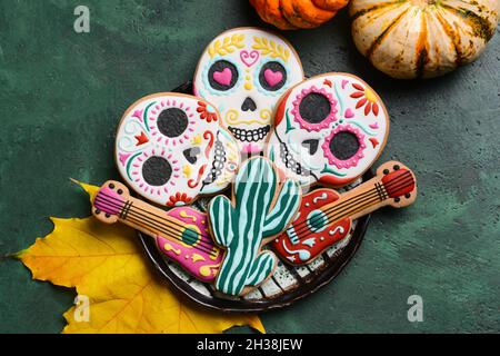 Teller mit Keksen für Mexikos Tag der Toten (El Dia de Muertos) auf grünem Hintergrund Stockfoto