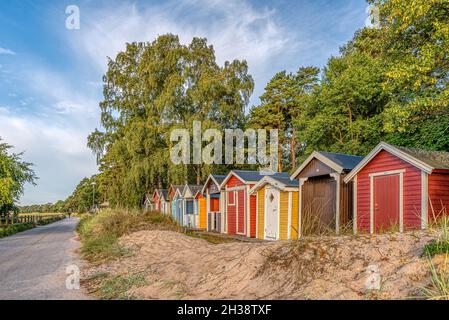 Niedliche Strandhütten in einer Reihe im Sand am Meer, Ystad, Schweden, 14. September 2021 Stockfoto