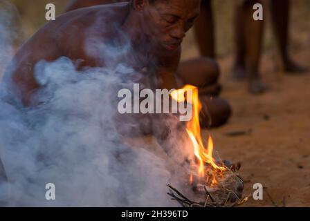 Buschmann, die auf dem primitiven Weg in Grashoek, Namibia, Feuer machen Stockfoto