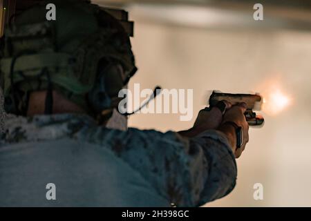 211021-M-ON629-1264 NAVAL SUPPORT ACTIVITY BAHRAIN (OKT 24, 2021) Marine, die der All Domain Reconnaissance Detachment, der 11. Marine Expeditionary Unit (MEU), zugewiesen wurde, feuert während eines kleinen Waffenrandes bei der Naval Support Activity Bahrain, 24. Oktober, eine M1911-Pistole. Die 11. MEU wird im Einsatzgebiet der 5. US-Flotte zur Unterstützung von Marineoperationen eingesetzt, um die maritime Stabilität und Sicherheit in der Zentralregion zu gewährleisten und das Mittelmeer und den Pazifik durch den westlichen Indischen Ozean und drei strategische Engpässe zu verbinden. (USA Marine Corps Foto von Sgt. Seth Rosenberg/Freigegeben) Stockfoto