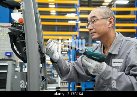 Shanghai. Oktober 2021. Ein Arbeiter arbeitet an einer Produktionslinie der Jungheinrich AG im Bezirk Qingpu im ostchinesischen Shanghai, 20. Oktober 2021. Die Jungheinrich AG, ein führender Anbieter von Intralogistik-Lösungen mit Sitz in Deutschland, wird in diesem Jahr zum vierten Mal an der China International Import Expo (CIIE) teilnehmen. Kredit: Ding Ting/Xinhua/Alamy Live Nachrichten Stockfoto