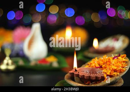 Diya oder Deep lit in Blattschüsseln auf Pattal oder Pattal Dona Katori, dekoriert mit Paan Shankh Roli Haldi und Blumen. Thema Für Diwali, Navratri Stockfoto