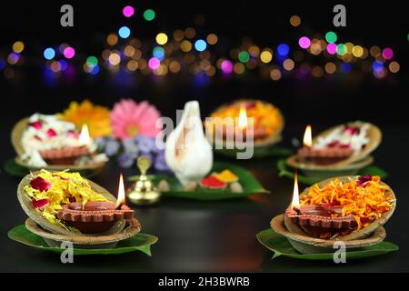 Diya oder Deep lit in Blattschüsseln auf Pattal oder Pattal Dona Katori, dekoriert mit Paan Shankh Roli Haldi und Blumen. Thema Für Diwali, Navratri Stockfoto