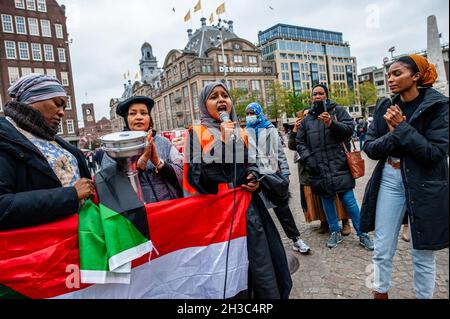 Amsterdam, Niederlande. Oktober 2021. Eine sudanesische Frau sah während der Demonstration Reden gegen die Militärherrschaft halten.in den Niederlanden lebende Sudanesen versammelten sich auf dem Dam-Platz im Stadtzentrum von Amsterdam, um gegen den Militärputsch im Sudan zu protestieren. Am Montag löste der Putschführer Gen Abdel Fattah Burhan die zivile Herrschaft auf, verhaftete politische Führer und rief den Ausnahmezustand aus. Eine große Zahl von Demonstranten fordert auf den Straßen der Hauptstadt die Rückkehr der zivilen Herrschaft. Kredit: SOPA Images Limited/Alamy Live Nachrichten Stockfoto