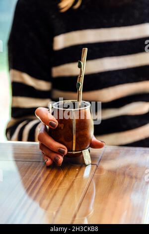 Junge Frau mit einem Mate in der Hand. Mate Tee aus Argentinien. Stockfoto