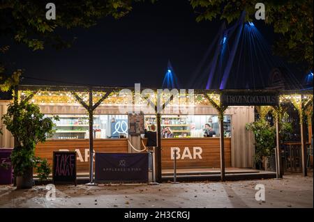 LONDON - 14. SEPTEMBER 2021: Menschen, die nachts an einer beleuchteten Bar in Londons Southbank arbeiten Stockfoto