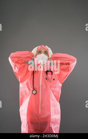 Medizinisches Personal trägt PSA und Maske mit Stress und müder Geste Stockfoto