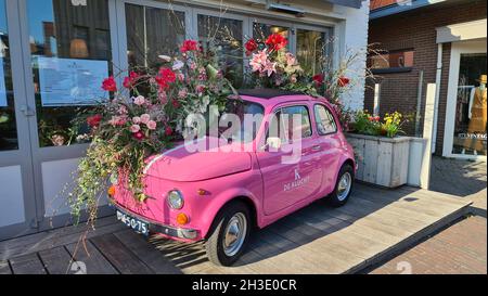 Pink Fiat 500 dekoriert mit Blumen als Dekoration vor einem Restaurant, Niederlande Stockfoto