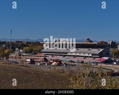 Blick auf die Stampede Grandstand in Calgary, Kanada, ein Stadion mit 17,000 Sitzplätzen und Stehplätzen für 8,000 Personen im Herbst mit den Rockies. Stockfoto