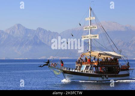 Das Touristenboot Poseidon fährt mit einer Gruppe von Touristen entlang der Küste Antalyas in der Südtürkei südlichste. Eine Meerjungfrau-Galionsfigur schmückt den Bogen. Stockfoto