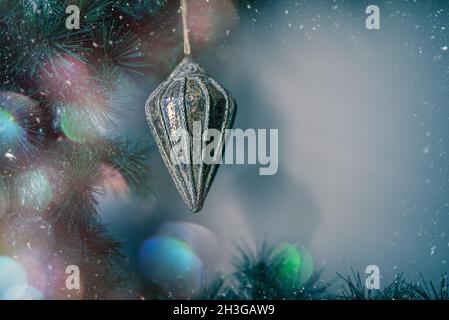 Schöne weihnachtsdekoration mit mehrfarbigem Bokeh auf den Tannenzweigen. Weihnachtskarte mit Kopierplatz. Stockfoto