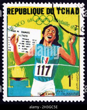 TSCHAD - UM 1969: Eine im Tschad gedruckte Briefmarke zeigt Colette Beschon, 400m Lauf, Gewinner der Olympischen Spiele 1968, Mexiko, um 1969 Stockfoto