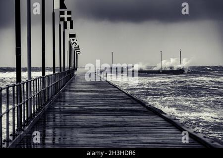 Moody Frankston Pier als Windy Storm Batters mit abstürzenden Wellen Stockfoto