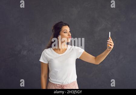 Die tausendjährige hispanische Frau spricht in einer Zelle über einen Videoanruf Stockfoto