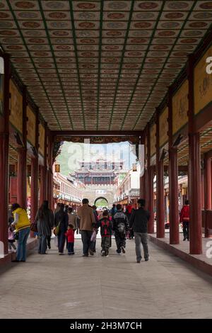 Innen von überdachter Brücke eingezäunter Gang mit aufwendig verzierten Decke. Blick auf das Südtor aus der Stadt Songpan in der Provinz Sichuan, China. (125) Stockfoto