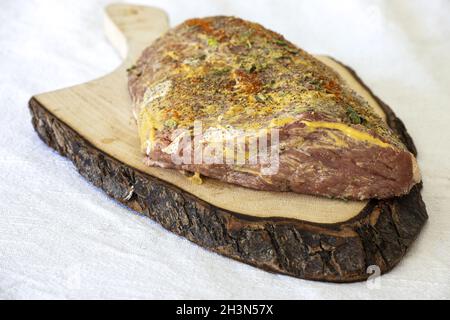 Mariniertes Fleisch auf einem Schneidebrett Stockfoto