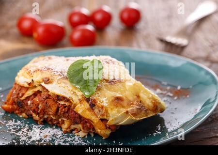 Italienische Lasagne auf blauem Teller Stockfoto