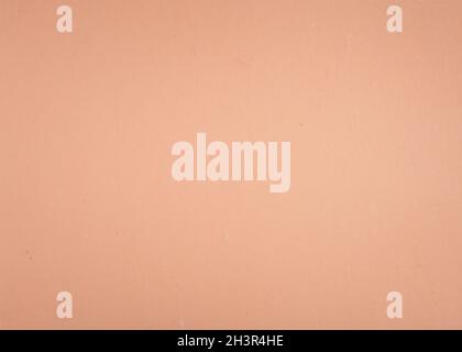 Strukturierter pastellrosa Papierhintergrund. Cremefarbene Oberfläche blank. Stockfoto