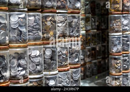 Münzen in Glasgefäße gelegt. Münzen vieler Länder, aus verschiedenen Metallen. Numismatik ist die Sammlung von Münzen oder Banknoten. Stockfoto
