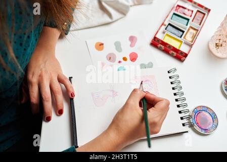 Illustrator Woman malt einige Skizzen mit Aquarellen Stockfoto
