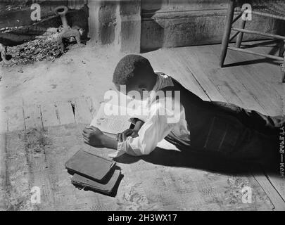 Young Boy, Boyd Jones, Doing His Homework on Wood Floor, Greene County, Georgia, USA, Jack Delano, U.S. Farm Security Administration, Fotosammlung des US Office of war Information, November 1941 Stockfoto