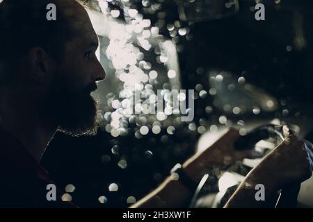 Man Fahrer sitzt am Lenkrad des Autos in der Nacht Stockfoto