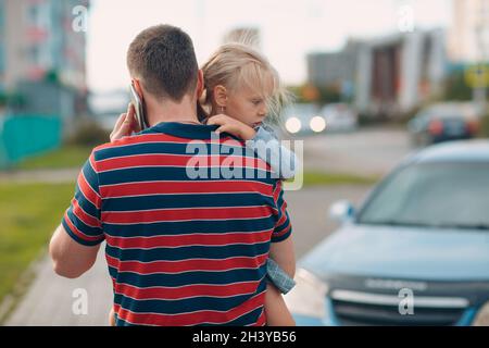 Rückansicht des Vaters, der mit seiner kleinen Tochter zur Kindertagesstätte ging. Stockfoto