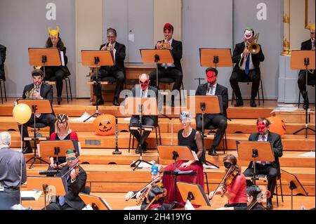 Hamburg, Deutschland. Oktober 2021. Im großen Saal der Laeiszhalle treten Musiker des Hamburger Symphonieorchesters mit bunten Halloween-Masken und etwas Halloween-Deko auf. Für das Halloween-Konzert zum Auftakt der Kinderkonzertsaison wurden junge und alte Gäste eingeladen, sich in die Laeiszhalle zu kleiden. Es war das erste Kinderkonzert nach einer langen Pause. Quelle: Jonas Walzberg/dpa/Alamy Live News Stockfoto