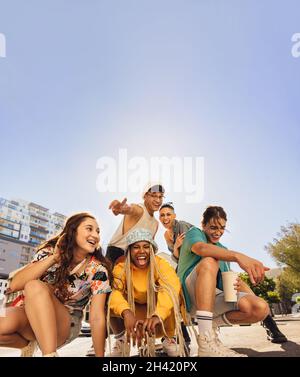 Diverse Freunde, die Spaß in der Stadt haben. Eine Gruppe von multiethnischen Freunden der Generation z, die gerne Zeit miteinander verbringen. Fröhliche junge Freunde mak Stockfoto