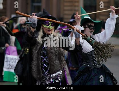 Frauen, die als Hexen von der Organisation Women Wont Wheesht gekleidet sind, treten am George Square, Glasgow, zu Beginn des Cop26-Gipfels in der Stadt auf. Bilddatum: Sonntag, 31. Oktober 2021. Stockfoto