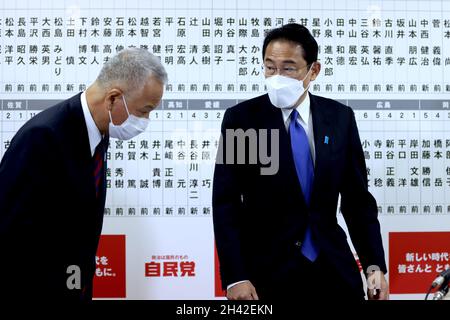 Tokio, Japan. Oktober 2021. Der amtierende Generalsekretär der Liberaldemokratischen Partei Japans, Akira Amari (L), verneigt sich nach den japanischen Parlamentswahlen in einem Zug am 31. Oktober 2021 vor dem Premierminister und Parteiführer Fumio Kishida (und R) am Parteihauptsitz in Tokio. (Bild: © POOL via ZUMA Press Wire) Stockfoto