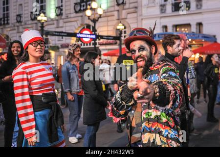 Piccadilly Circus, London, Großbritannien. Oktober 2021. Ein Zombie-Teilnehmer lächelt, während er tanzt. Feiernden nehmen an einem Halloween-Tanz-Flashmob Teil, darunter eine Gruppe von Locals.org, einer sozialen Plattform mit Sitz in London, und treffen sich, um Londoners zusammenzubringen. Passanten werden ermutigt, mitzumachen und zu tanzen. Kredit: Imageplotter/Alamy Live Nachrichten Stockfoto