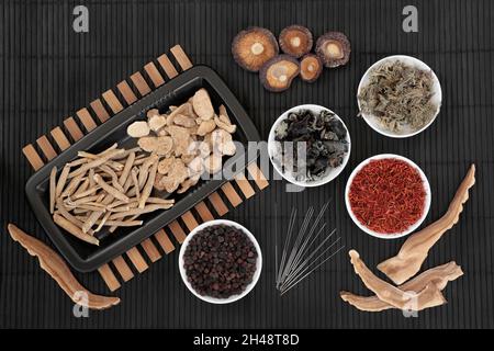 Chinesische Akupunkturnadeln mit traditionellen Kräutern, Gewürz, das in alten pflanzlichen Heilbehandlungen verwendet wird. Natürliches ganzheitliches Gesundheitskonzept. Stockfoto