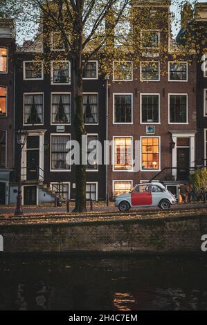 Oldtimer in einem Kanal von Amsterdam, Holland geparkt Stockfoto