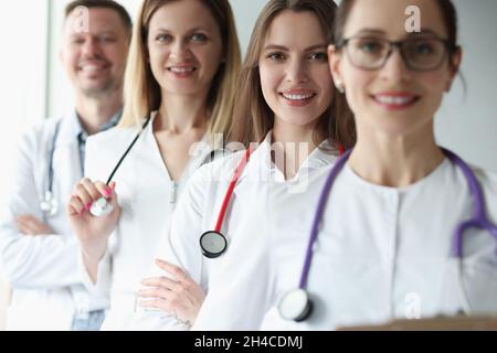 Gruppe von fröhlich Praktizierenden jungen Ärzten in Uniform Stockfoto