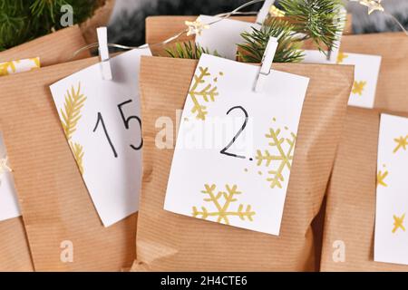 Selbstgemachter Adventskalender aus handgeschriebenen Papiertüten mit handschriftlichen Nummern Stockfoto