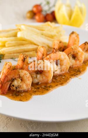 Gebratene, gegrillte und knusprige Garnelen mit Kartoffelfingern Stockfoto
