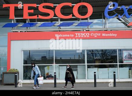 Einkäufer mit Schutzmaske vor einem Tesco Extra Supermarkt im Norden Londons. Ausgabedatum: Donnerstag, 2. April 2020. Stockfoto